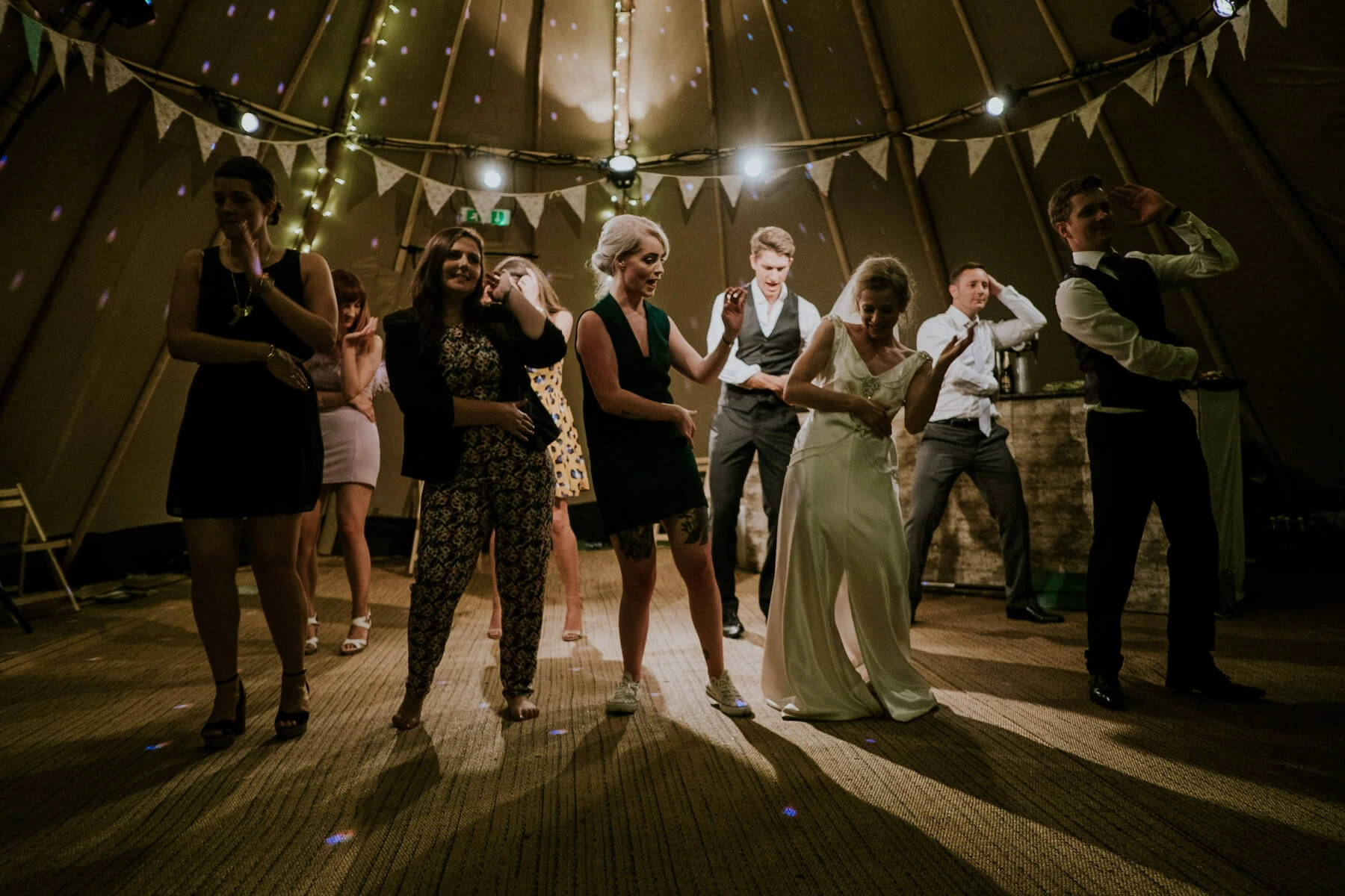 Bride and groom dancing alongside the rest of the wedding party