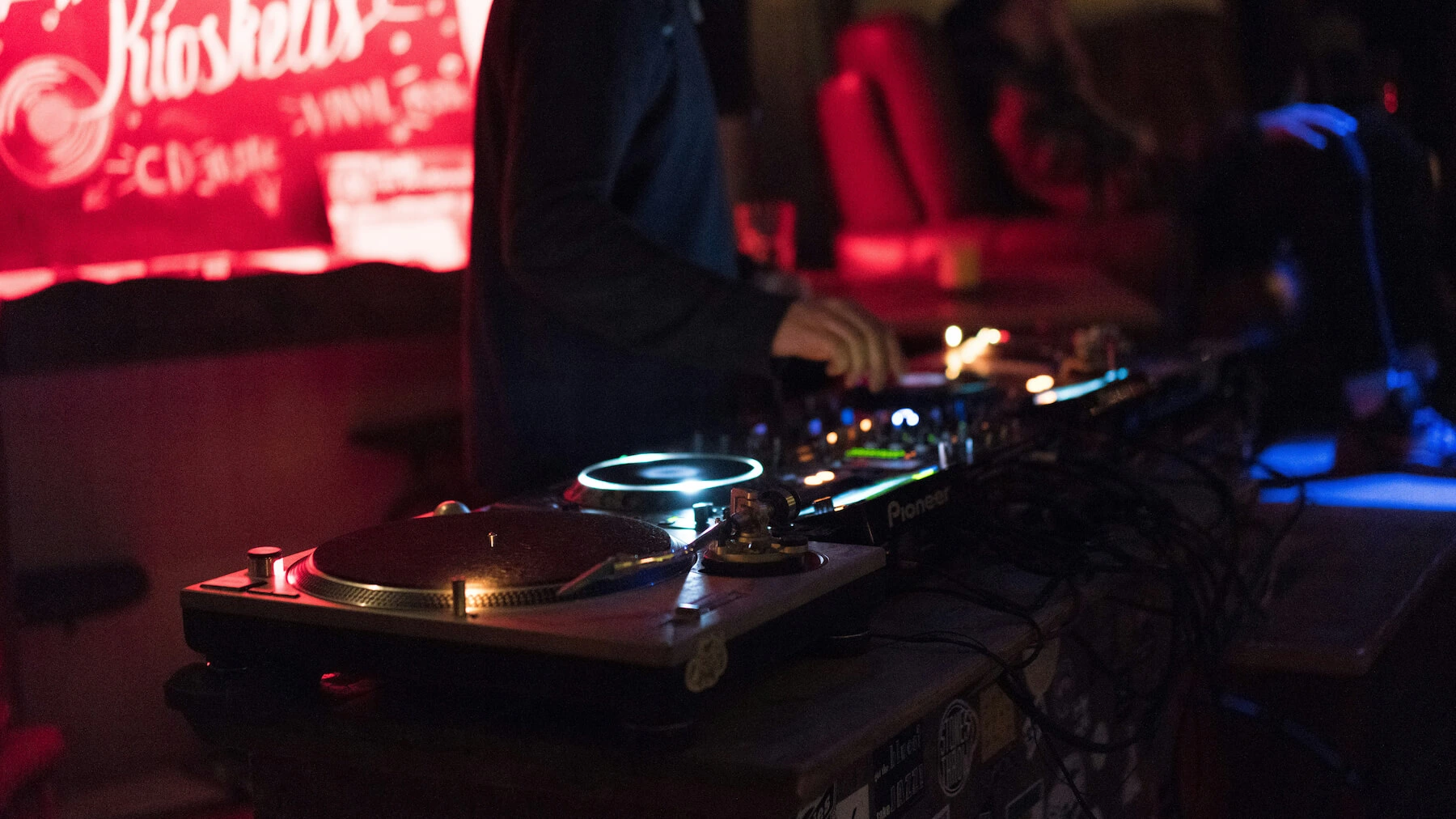 One of our DJs performing at a festival-style wedding, using Technics turntables and Pioneer DJ equipment
